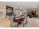 Bright dining room with a large table, chandelier, and views into the living room and kitchen at 12519 W Bajada Rd, Peoria, AZ 85383