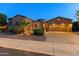 Stunning desert home with appealing stone elevation, landscaping, and a three-car garage at 12519 W Bajada Rd, Peoria, AZ 85383