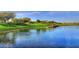 Serene lake view with lush green landscaping at 12519 W Bajada Rd, Peoria, AZ 85383
