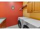 Bright laundry room, washer, dryer, cabinets, and utility sink at 12519 W Bajada Rd, Peoria, AZ 85383