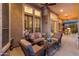 Relaxing covered patio with comfortable seating and views of the backyard at 12519 W Bajada Rd, Peoria, AZ 85383