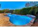 Inviting backyard oasis featuring a freeform pool, spa, and waterfall feature at 12519 W Bajada Rd, Peoria, AZ 85383