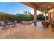 Relaxing backyard with a pool, spa, and covered patio with seating at 12519 W Bajada Rd, Peoria, AZ 85383