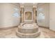 Spa-like bathroom with a raised soaking tub and block windows at 14047 E Lowden Ct, Scottsdale, AZ 85262