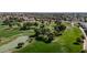 Scenic aerial view of a lush golf course with mature trees, ponds, and surrounding homes at 14200 W Village Pkwy # 113, Litchfield Park, AZ 85340