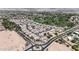 Panoramic aerial view of a housing community, golf course and desert landscape at 14200 W Village Pkwy # 113, Litchfield Park, AZ 85340