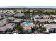An aerial view showcases the community pool, lush greenery, and well-maintained residences at 14200 W Village Pkwy # 113, Litchfield Park, AZ 85340