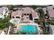 Stunning aerial view of the backyard oasis featuring a sparkling pool, spa, and multiple lounge areas perfect for entertaining at 14200 W Village Pkwy # 113, Litchfield Park, AZ 85340