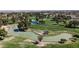 Picturesque aerial view of a well-maintained golf course with serene ponds and mature trees at 14200 W Village Pkwy # 113, Litchfield Park, AZ 85340