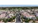 Neighborhood aerial view of palm-lined streets, single-Gathering homes, and proximity to golf course at 14200 W Village Pkwy # 113, Litchfield Park, AZ 85340