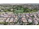 Wide aerial showcases community layout, golf course, nearby homes, and a community pool at 14200 W Village Pkwy # 113, Litchfield Park, AZ 85340