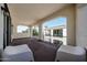 Spacious balcony with stone archways and wrought iron railings, offering serene neighborhood views at 14200 W Village Pkwy # 113, Litchfield Park, AZ 85340