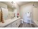 Bright bathroom featuring a single vanity, shower over tub, and a modern mirror with updated fixtures at 14200 W Village Pkwy # 113, Litchfield Park, AZ 85340