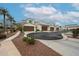 Attractive exterior of a light-colored, two-story townhome with a brown garage door and landscaping at 14200 W Village Pkwy # 113, Litchfield Park, AZ 85340