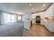 Modern kitchen featuring white cabinets, stainless steel appliances, a breakfast bar, and stylish tile backsplash at 14200 W Village Pkwy # 113, Litchfield Park, AZ 85340