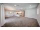 Open concept living room with a kitchen island, modern chandelier, and neutral carpet at 14200 W Village Pkwy # 113, Litchfield Park, AZ 85340