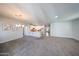Spacious living area with open floor plan, breakfast bar, and sleek kitchen featuring modern finishes at 14200 W Village Pkwy # 113, Litchfield Park, AZ 85340