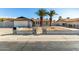 House exterior featuring gray paint, palm trees, and a well-maintained front yard at 14219 N 51St Dr, Glendale, AZ 85306