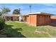 Large backyard, brick building, and grassy area at 1435 E Rose Ln, Phoenix, AZ 85014