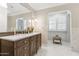 Elegant bathroom with a large vanity, marble floors, and a spacious shower at 1435 E Rose Ln, Phoenix, AZ 85014