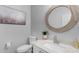Clean bathroom with a large mirror and white vanity at 1448 N 80Th Dr, Phoenix, AZ 85043