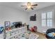 bedroom with TV, storage, and play area at 1448 N 80Th Dr, Phoenix, AZ 85043