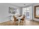Dining area features a white table with four chairs and access to a patio at 1448 N 80Th Dr, Phoenix, AZ 85043