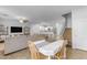 Bright dining area with a white table and four chairs, overlooking the living room and kitchen at 1448 N 80Th Dr, Phoenix, AZ 85043