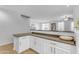 Kitchen features white shaker cabinets and a peninsula at 1448 N 80Th Dr, Phoenix, AZ 85043
