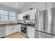 Bright kitchen with white cabinets, stainless steel appliances, and a rich brown countertop at 1448 N 80Th Dr, Phoenix, AZ 85043