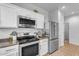 White kitchen with stainless steel appliances and a built in microwave at 1448 N 80Th Dr, Phoenix, AZ 85043