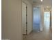 Bright hallway with tile flooring and doors to bedrooms at 15781 W Hackamore Dr, Surprise, AZ 85387