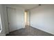 Spacious bedroom with neutral walls, gray carpet, and double-door closet at 15790 W Hackamore Dr, Surprise, AZ 85387