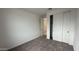 Simple bedroom with neutral walls, gray carpet, and double-door closet at 15790 W Hackamore Dr, Surprise, AZ 85387