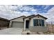 New single-story home with gray exterior, two-car garage, and blue shutters at 15790 W Hackamore Dr, Surprise, AZ 85387