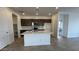 Modern kitchen with island, dark brown cabinets, and quartz countertops at 15790 W Hackamore Dr, Surprise, AZ 85387