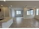 Open living area with tile flooring and large windows offering natural light at 15790 W Hackamore Dr, Surprise, AZ 85387
