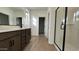 Modern bathroom with double vanity, large mirror and walk-in shower at 15797 W Hackamore Dr, Surprise, AZ 85387
