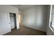 Spacious bedroom with neutral walls, carpeting, and a sliding door closet at 15797 W Hackamore Dr, Surprise, AZ 85387