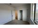 Bright bedroom with neutral walls, carpeting, and a door to the bathroom at 15797 W Hackamore Dr, Surprise, AZ 85387