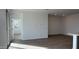 Open living area with tile flooring and access to a sliding glass door at 15797 W Hackamore Dr, Surprise, AZ 85387