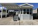 Mobile home exterior with covered patio and landscaping at 17200 W Bell Rd # 196, Surprise, AZ 85374