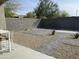 Low-maintenance backyard featuring gravel, pavers, and desert landscaping enclosed by a block wall for privacy at 17403 W Eagle Ct, Goodyear, AZ 85338