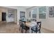 Bright dining area with a rustic wooden table and four black chairs at 17403 W Eagle Ct, Goodyear, AZ 85338