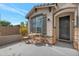 Inviting front exterior with a patio seating area and dark gray front door at 17403 W Eagle Ct, Goodyear, AZ 85338