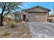 Tan house exterior with two car garage and landscaping at 17403 W Eagle Ct, Goodyear, AZ 85338