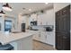 Modern kitchen with white cabinets and stainless steel appliances at 17403 W Eagle Ct, Goodyear, AZ 85338