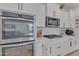 Modern kitchen features stainless steel appliances and white cabinetry at 17403 W Eagle Ct, Goodyear, AZ 85338
