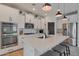 Modern kitchen with white cabinets, stainless steel appliances, and large island at 17403 W Eagle Ct, Goodyear, AZ 85338