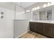 Modern bathroom with double vanity, large shower, and wood floors at 17440 W Eugene Ter, Surprise, AZ 85388